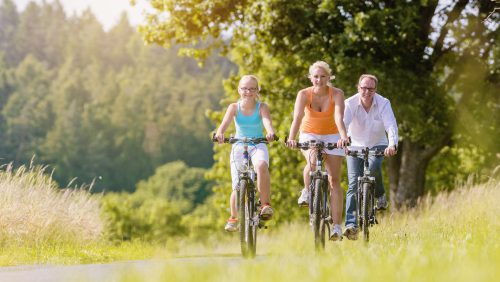 Family having weekend bicycle tour outdoors