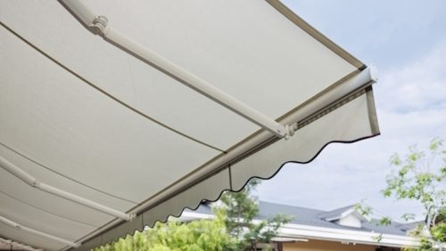 White,Fabric,Awning,With,The,Garden,Background.,White,Canvas,Sun